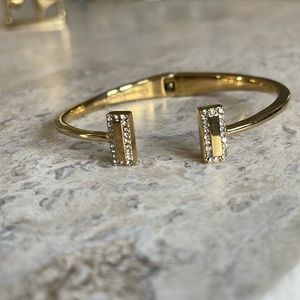 Kate Spade open cuff gold tone bracelet with rhinestones.